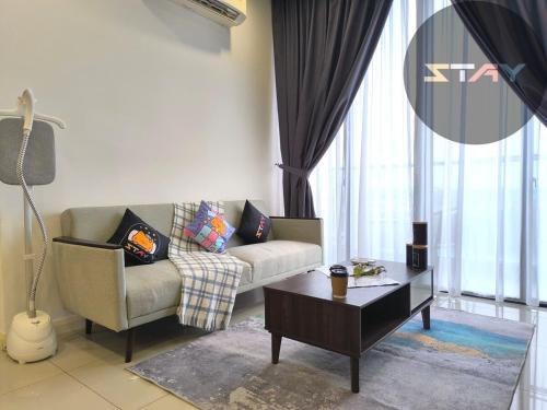 a living room with a couch and a coffee table at D'Pristine 6Pax Tranquil Lakeview Netflix By STAY in Iskandar Puteri