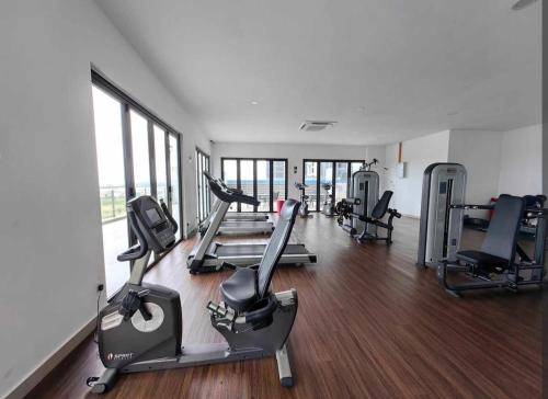 a gym with several treadmills and elliptical machines at D'Pristine 6Pax Tranquil Lakeview Netflix By STAY in Iskandar Puteri