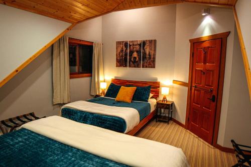 a hotel room with two beds and a window at GrizzPaw Lodge - Mountain Resort - 5 Bedroom Chalet - Sleeps 14 People in Golden