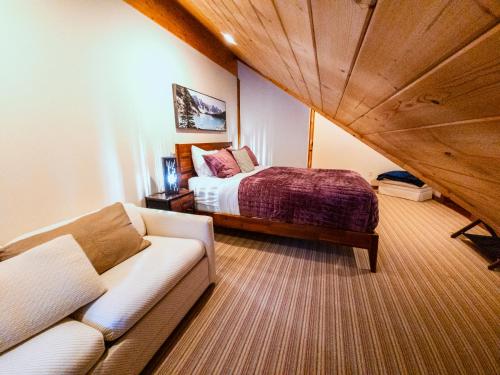 a living room with a couch and a bed at GrizzPaw Lodge - Mountain Resort - 5 Bedroom Chalet - Sleeps 14 People in Golden