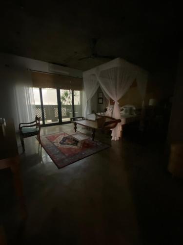 a bedroom with a bed and a table in a room at Olinda Galle in Galle