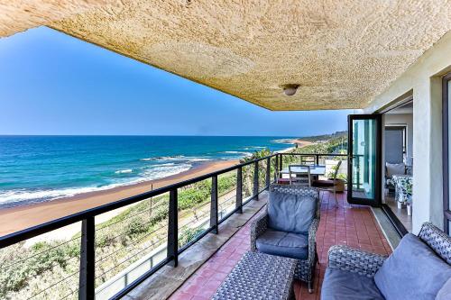 a balcony with a view of the ocean at La Pirogue 1 in Westbrook