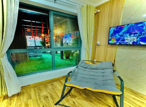 a chair sitting in a room with a window at Pine Forest House Dalat in Xuan An