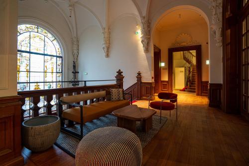 a living room with a couch and a table at CENTRAL Hôtel Lille Centre in Lille