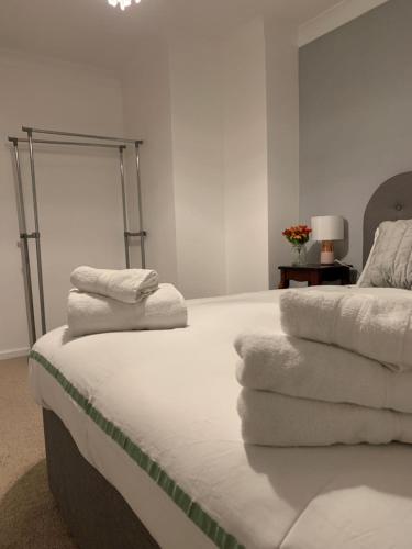 a bedroom with a bed with towels on it at Pallister House Middlesbrough in Middlesbrough