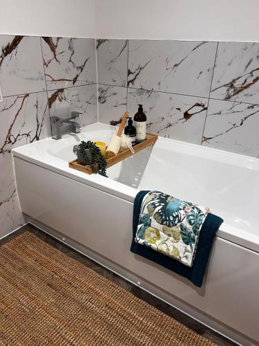 a bathroom with a bath tub with a towel on it at 5BR for 9 l BIG Parking l Perfect for Contractors in Higham on the Hill
