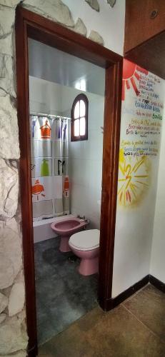 a bathroom with a pink toilet and a sink at Alfonsina y el Mar in Mar del Plata
