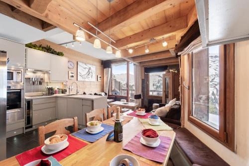 a kitchen and dining room with a table and chairs at Luxury Avoriaz Chalet with hot tub in Avoriaz