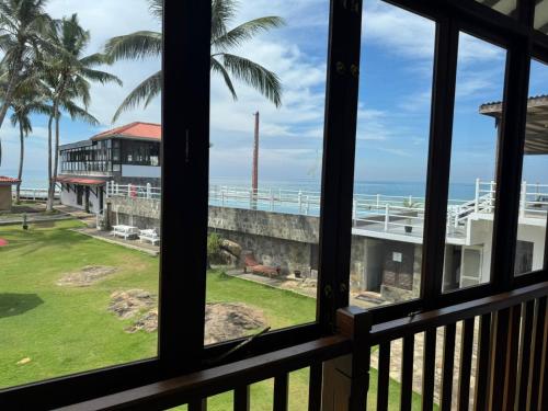 a view of the ocean from a balcony at Amara White Villa in Ahungalla