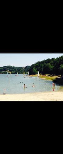 a group of people in the water at a beach at Mobilhome les pieds dans l eau avec piscine in Saint-Gérons