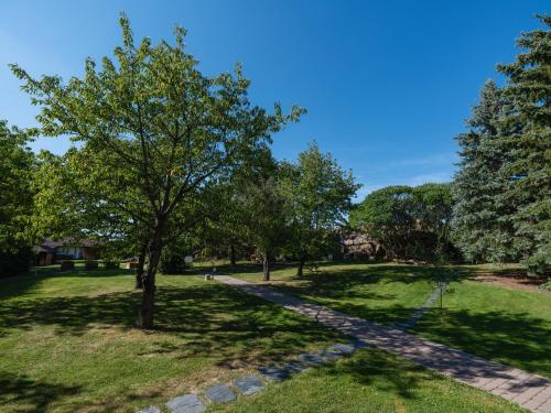 a path in a park with trees and grass at Resort po.spolu in Mokrovraty