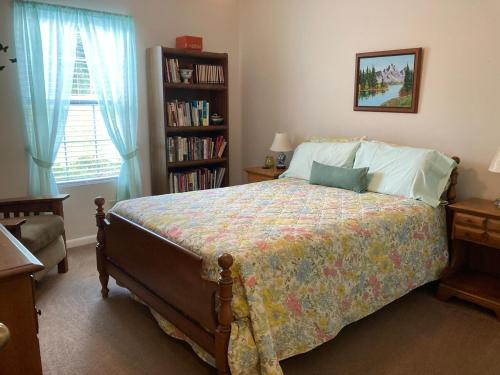 a bedroom with a bed and a book shelf at Rose's House in Lanett