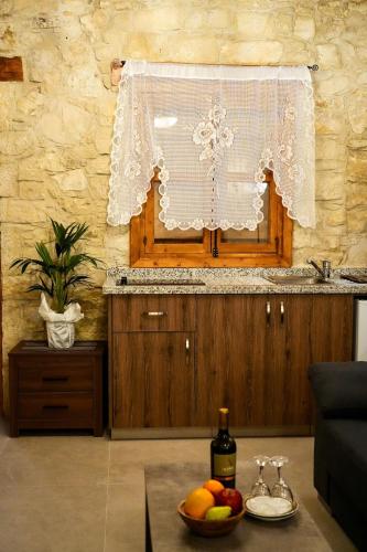 a kitchen with a table with a bowl of fruit at Vouni Calais in Vouni