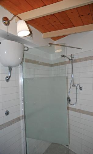 a bathroom with a shower with a glass door at Brezzolina Apartment with parking in Bitonto