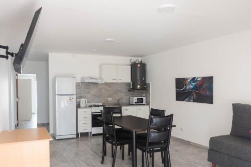 a kitchen and dining room with a table and chairs at Bahia Urban Apartments in Bahía Blanca