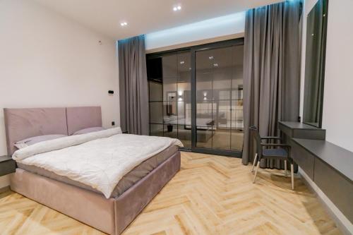 a bedroom with a large bed and a desk and a desk at White villas in Qusar