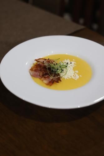 a white plate with a piece of food on it at Vershyna in Dragobrat