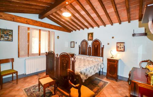 a bedroom with a bed and a chair and a table at Beautiful Home In Cortona With Wifi in Cortona