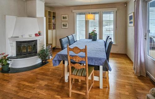 a dining room with a table and a fireplace at 4 Bedroom Awesome Home In Sandefjord in Sandefjord