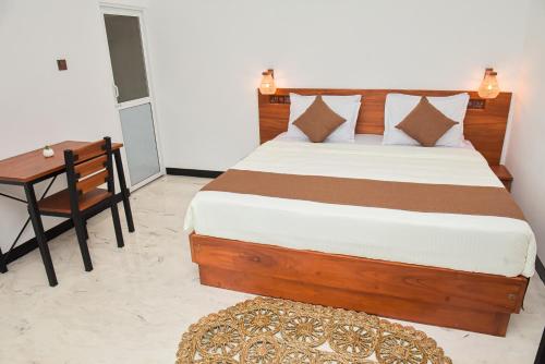a bedroom with a bed and a table and a desk at Tea Hills Ella in Ella