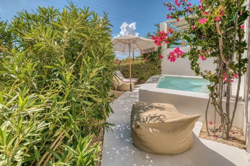 a garden with a swimming pool and some plants at Onikos House - South Gem in Kampos Paros