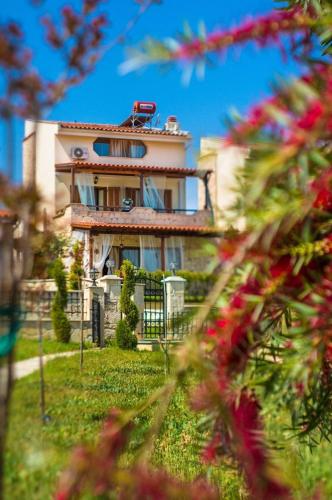 a large house with a fence in front of it at Villa Natalia in Afitos