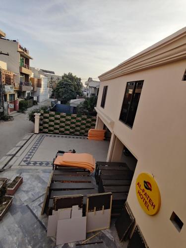 a balcony of a house with a bed and chairs at AL Fateh Hotel in Lahore