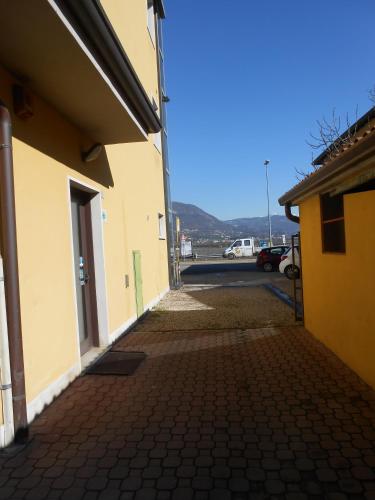 an alley between two buildings with a parking lot at Albergo Villa Eva in Costermano sul Garda