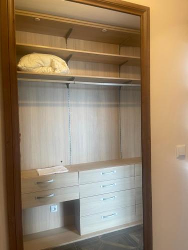a closet with white drawers and a bed in it at Admiral Plaza Apartments in Sunny Beach