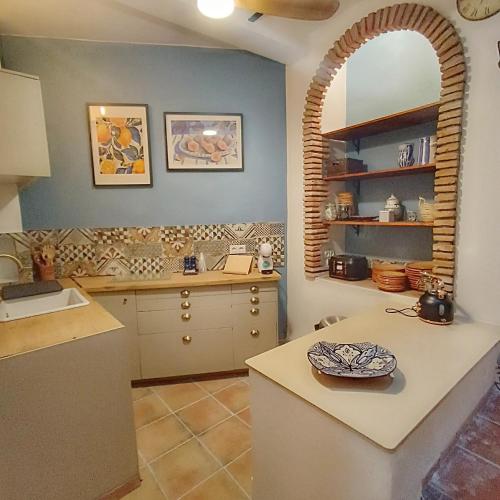 a kitchen with a sink and a counter top at La Biznaga - Comares in Comares