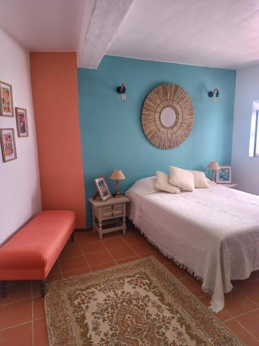 a bedroom with a bed and a mirror on the wall at La Biznaga - Comares in Comares