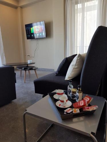 a living room with a couch and a table at City Center Apartment Project by Cretan Houses in Heraklio