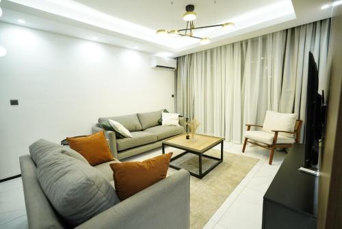 a living room with a couch and a table at An Oasis in the heart of Kigali in Kigali