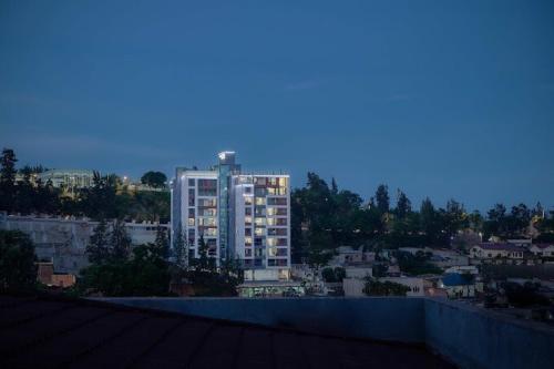 a view of a city with a tall building at An Oasis in the heart of Kigali in Kigali