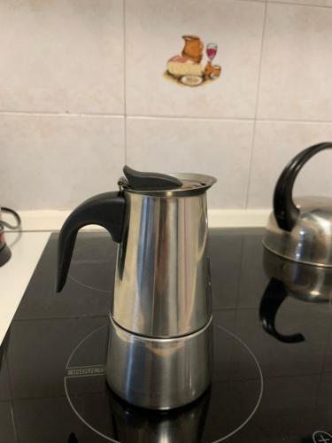 a tea kettle sitting on top of a stove at For Rest Aparthotel in St Paul's Bay