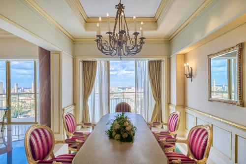 a dining room with a table and chairs and a chandelier at Hilton Cairo Grand Nile in Cairo