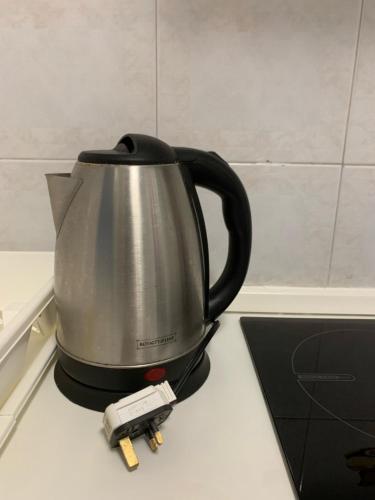 a tea kettle on top of a counter with a scale at For Rest Aparthotel in St Paul's Bay
