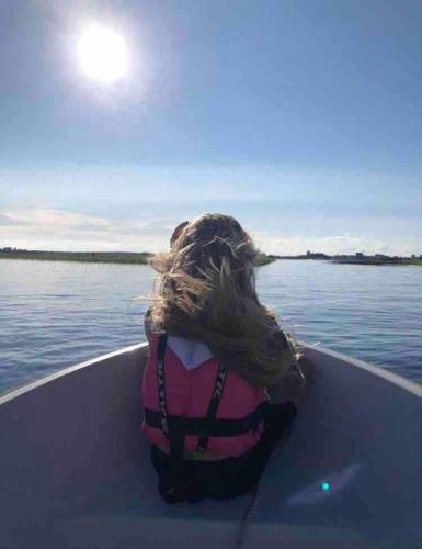 a person in a boat on the water at Solbackens guesthouse with sauna by the lake in Hammarö
