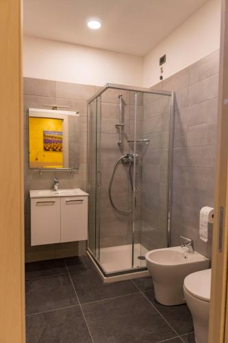 a bathroom with a shower and a toilet and a sink at Casa Fortuna in Monfalcone