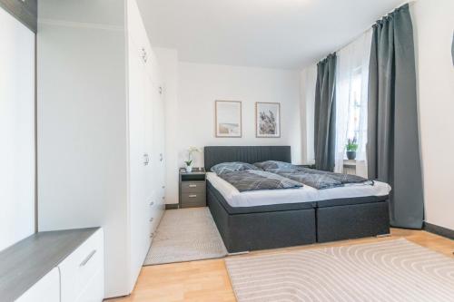 a bedroom with a bed in a white room at Hotel Essen 61 2 Zimmer Apartment in Essen