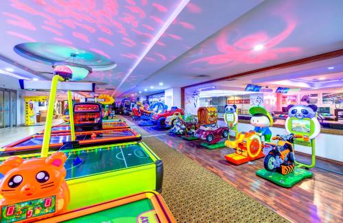 a gaming room with several games and a pinball machine at Bera Alanya Hotel - Halal All Inclusive in Konaklı