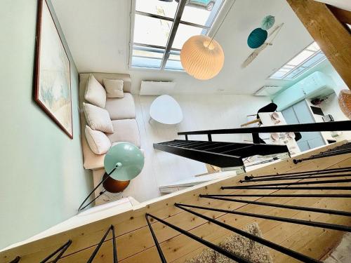 une mezzanine avec un escalier et un salon dans l'établissement Blue Beach Les Sables d'Olonne, à Les Sables-dʼOlonne