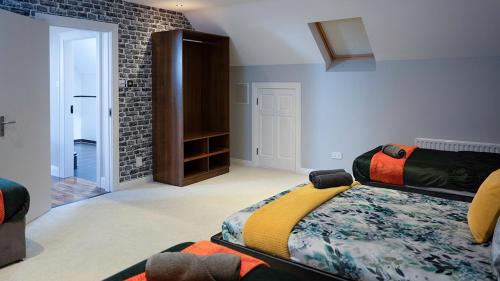 a bedroom with a bed and a brick wall at Dawn Chorus house, Ravensdale in Dundalk