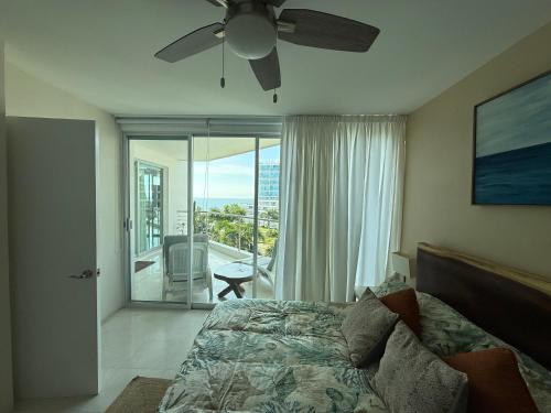 a bedroom with a bed and a ceiling fan at Semana Santa frente al mar con dos terrazas del 30 de marzo al 5 de abril Semana pascua 6 al 12 abril in Nuevo Vallarta