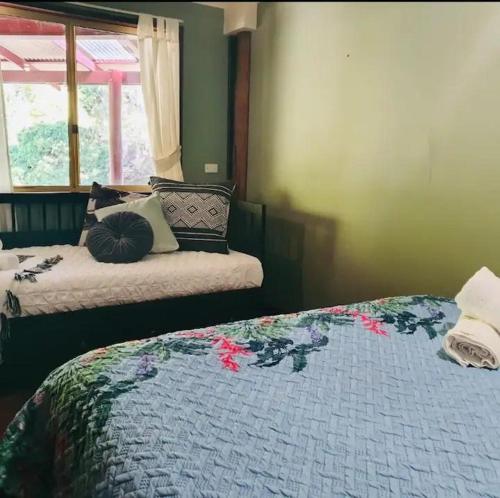 a bedroom with two beds and a window at Pemberton Forest View Retreat in Pemberton