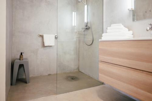 a shower with a glass door in a bathroom at The Layhead B&B in Lübeck