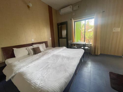a large bed in a room with a window at Oxygen Homestay-A Blissful Retreat in Dehradun