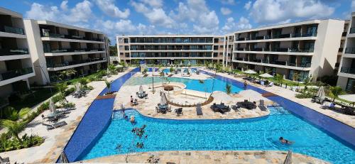 an overhead view of a swimming pool in a resort at Malia Beach Experience - Studios em Muro Alto por Yolo in Ipojuca