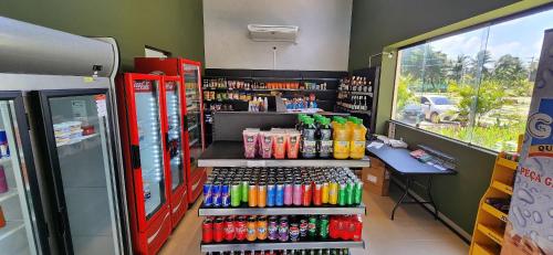 a soda shop with a lot of soda bottles at Malia Beach Experience - Studios em Muro Alto por Yolo in Ipojuca