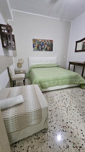 a bedroom with two beds and a chair at Le Terrazze in Carini